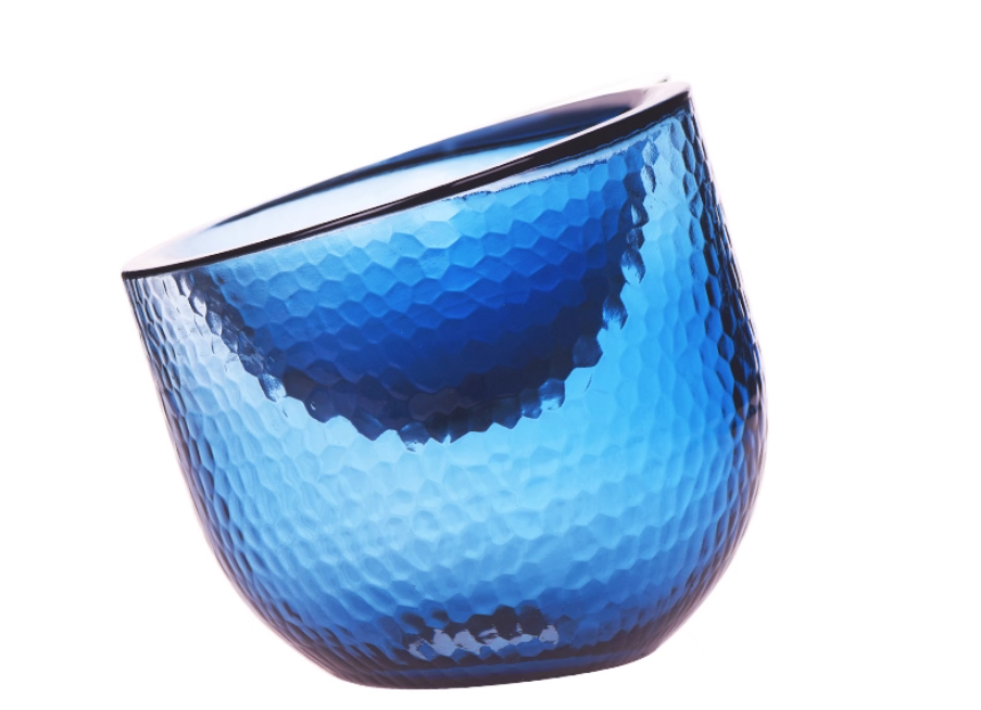 Blue glass vase with a textured surface on a white background
