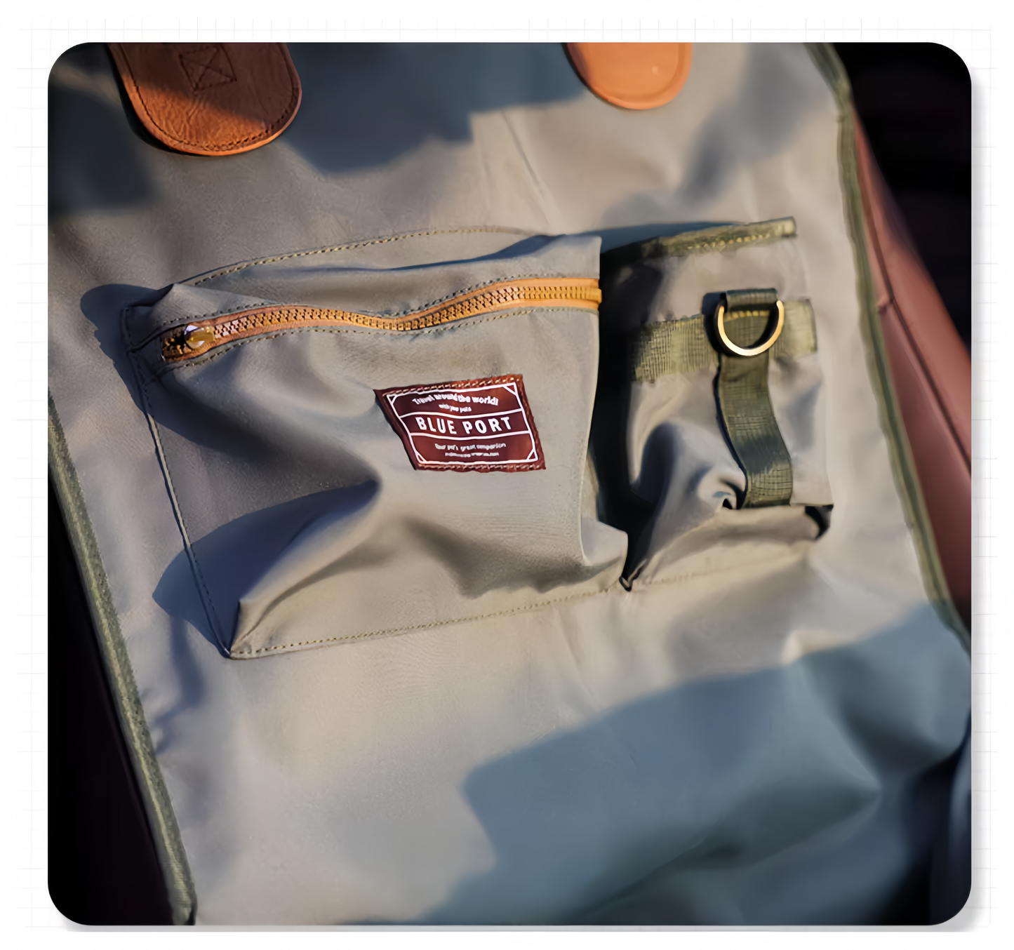 Gray backpack with orange zipper and visible brand label on a dark background