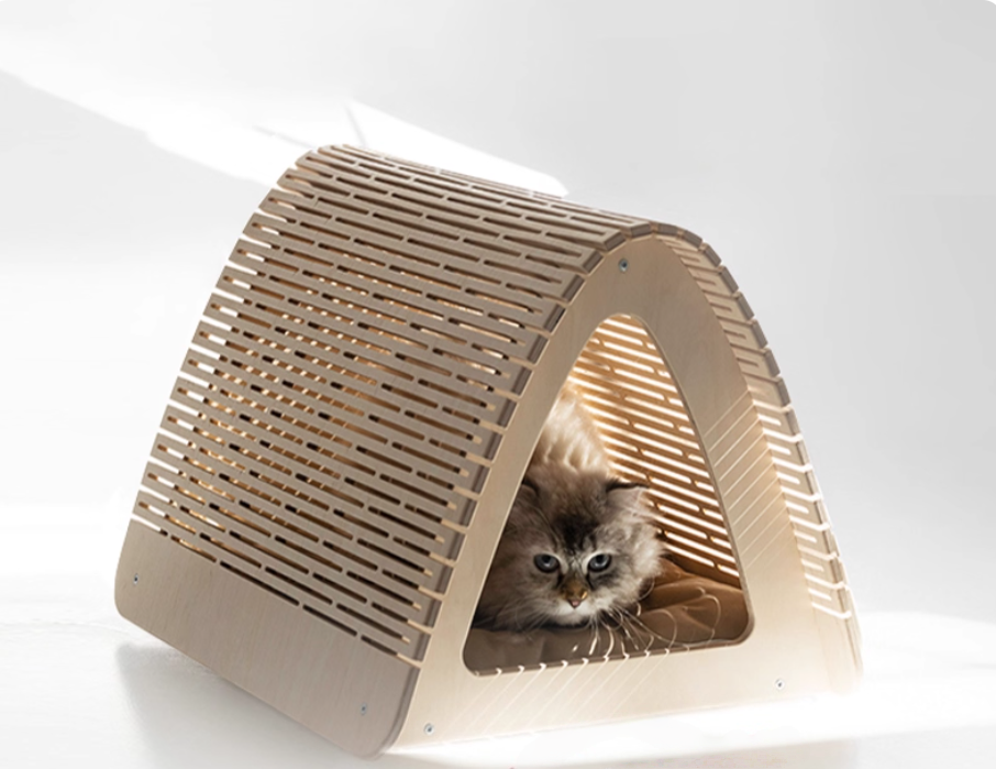 Cat peeking out from a modern cardboard cat house on a white background